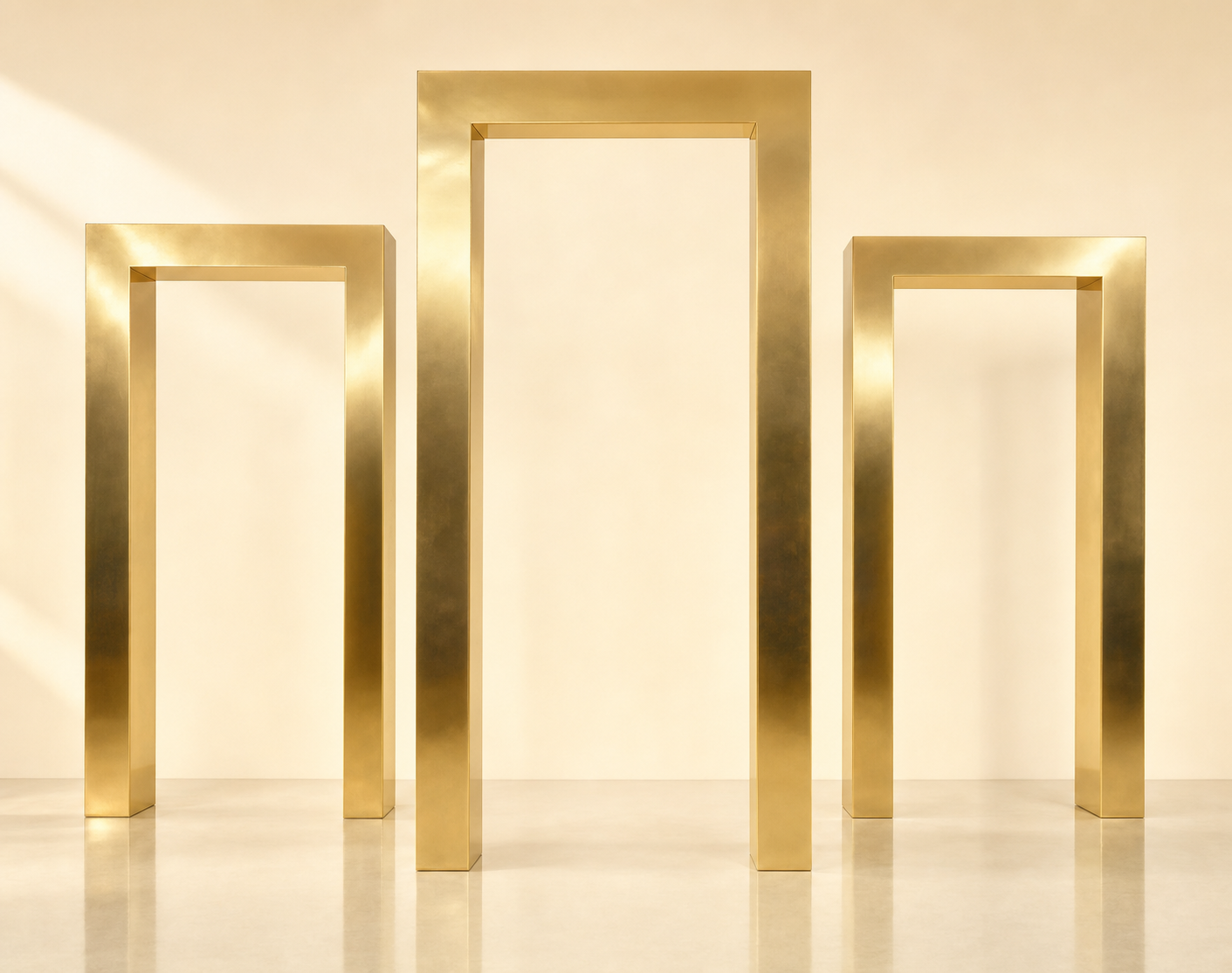 Trio of tall polished gold rectangular arches at varying heights