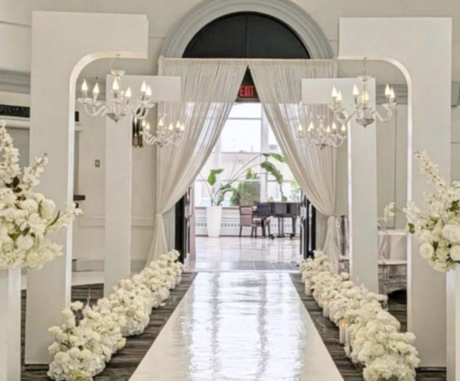 Ceremony aisle with mirror walkway and cascading florals