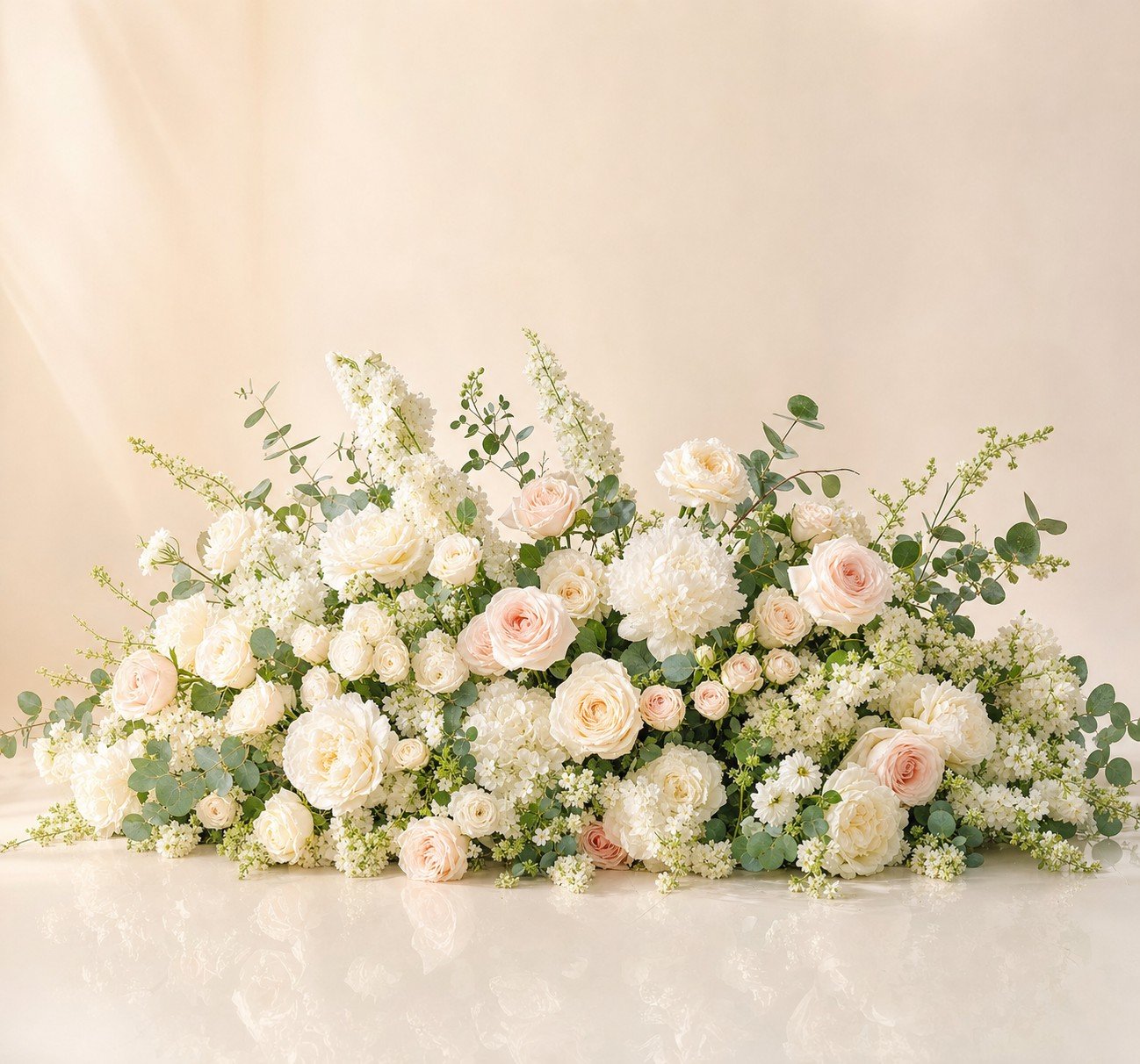 Lush aisle floor floral cluster with ivory and blush roses