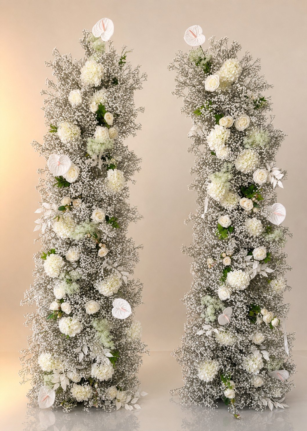 Tall babys breath floral pillars with white roses and anthurium accents