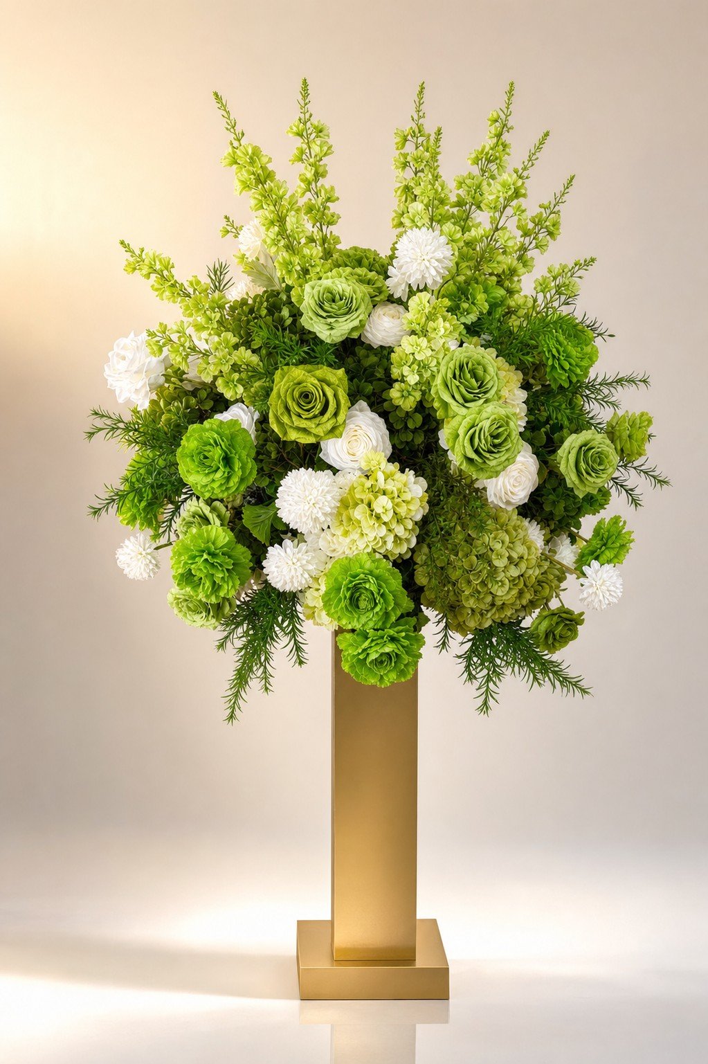 Green and white pedestal centerpiece with ranunculus and roses