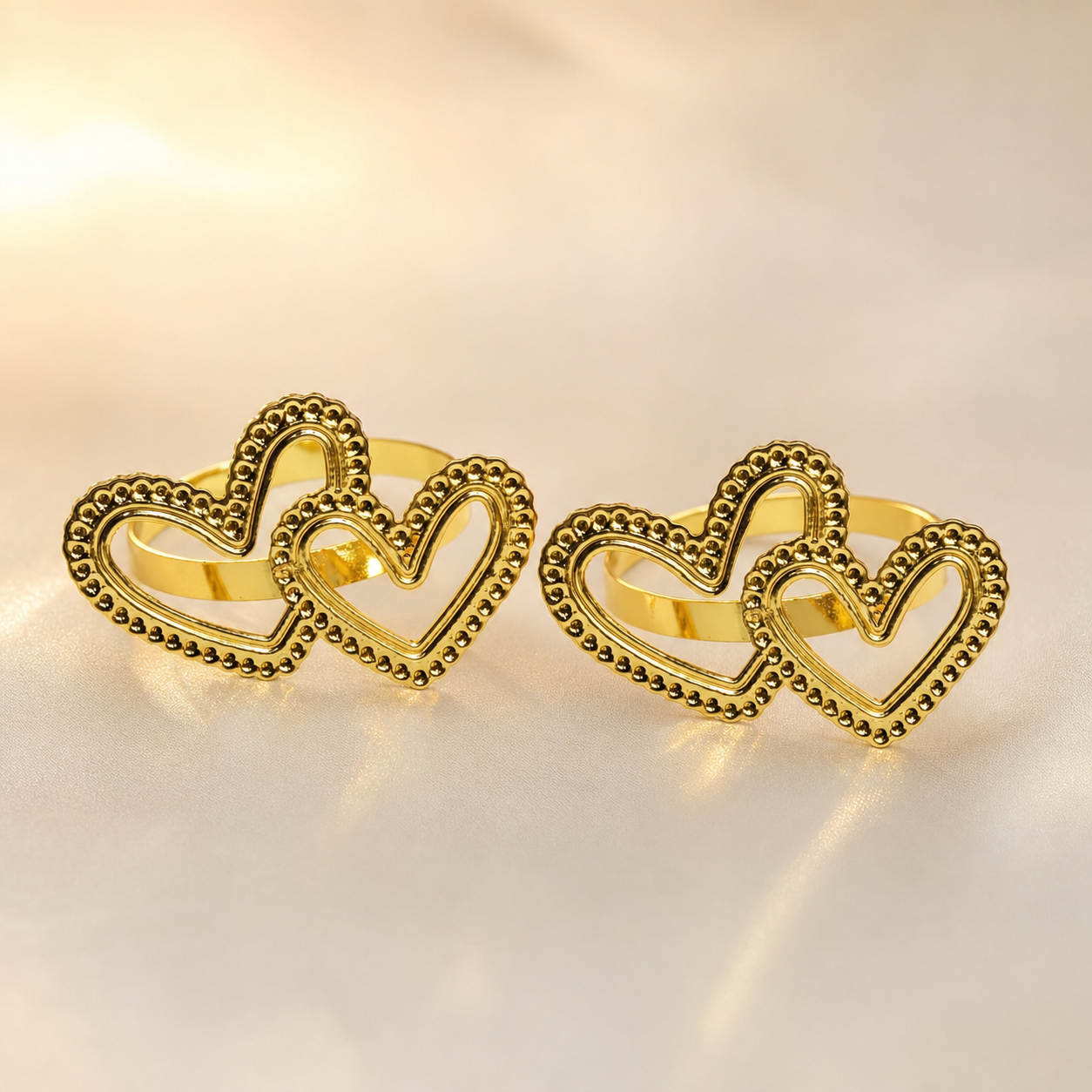 Pair of gold beaded double-heart napkin rings